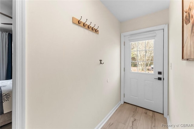 entryway featuring light wood-type flooring and baseboards