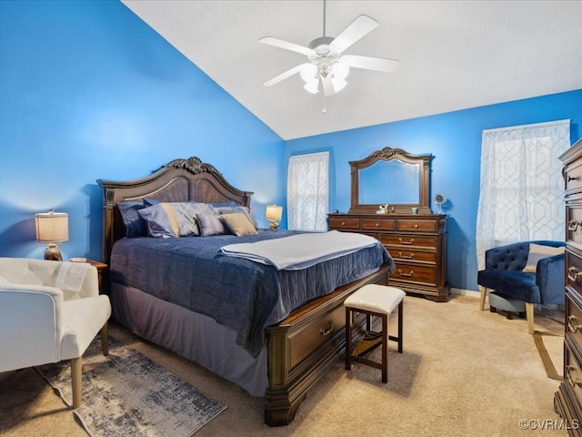 bedroom with light carpet, ceiling fan, baseboards, and vaulted ceiling