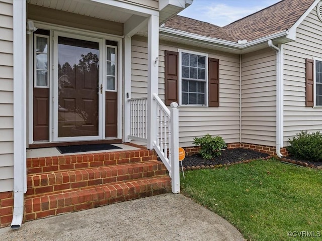 doorway to property featuring roof with shingles