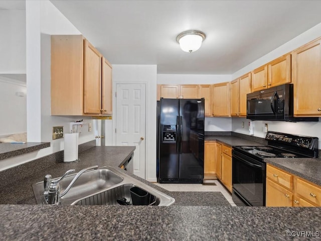 kitchen with light brown cabinets, black appliances, dark countertops, and a sink