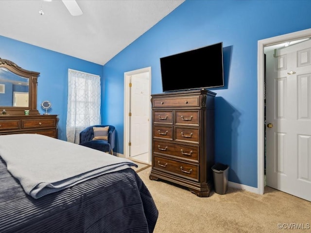 bedroom featuring lofted ceiling, ceiling fan, light carpet, and baseboards