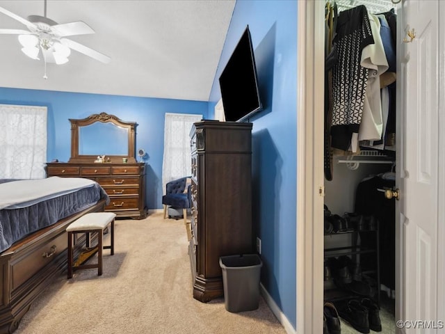 bedroom featuring lofted ceiling, light colored carpet, ceiling fan, and baseboards