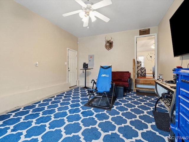 interior space with carpet, electric panel, and ceiling fan