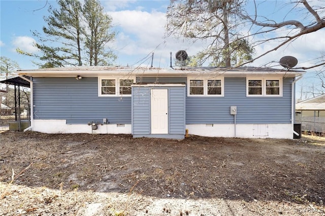 rear view of property featuring crawl space