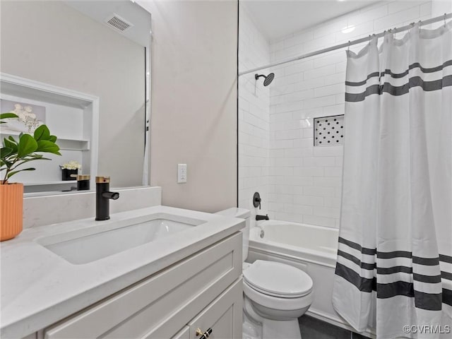 bathroom featuring visible vents, vanity, toilet, and shower / bath combo with shower curtain