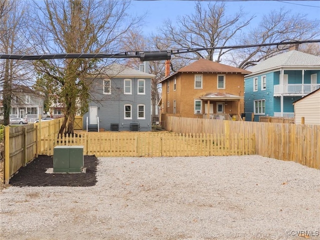 view of yard with a residential view, fence private yard, and entry steps