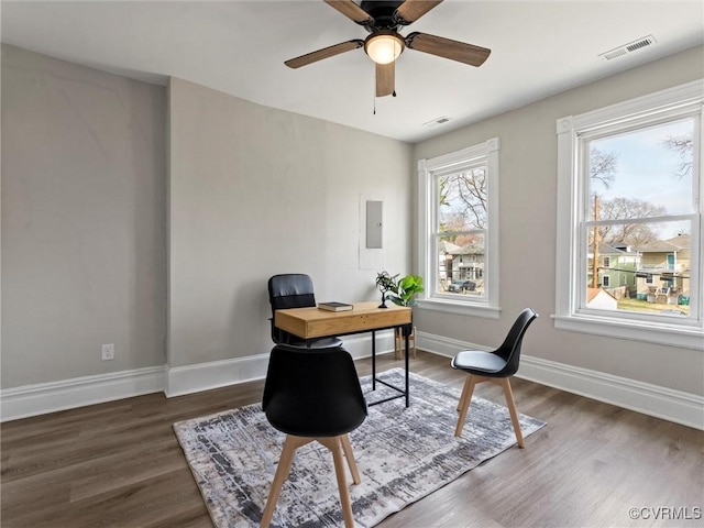 office area featuring visible vents, baseboards, and wood finished floors