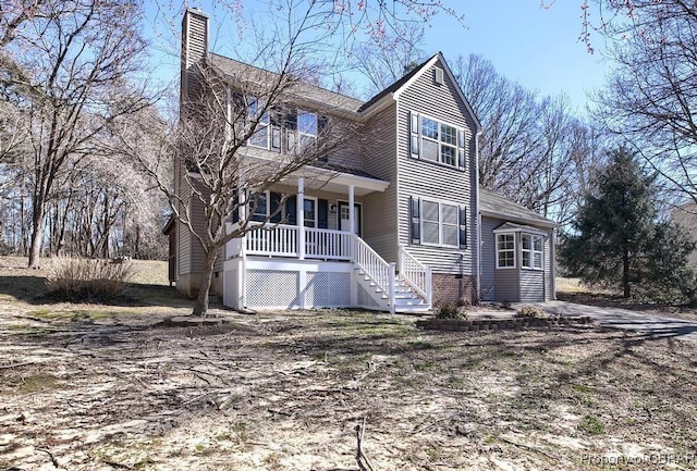 view of front of property with covered porch and a chimney