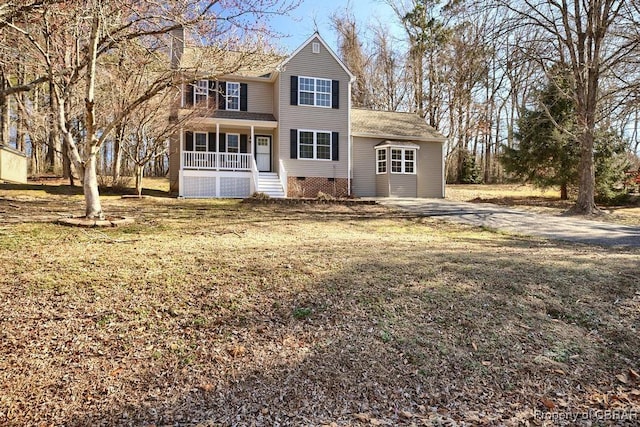 traditional home featuring a front yard, crawl space, and covered porch