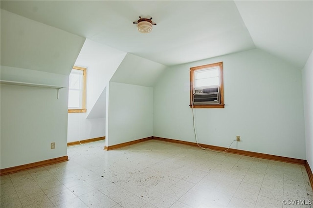 bonus room with baseboards, cooling unit, and tile patterned floors