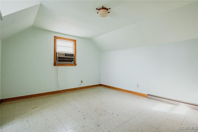 additional living space with baseboards, lofted ceiling, a baseboard radiator, cooling unit, and light floors