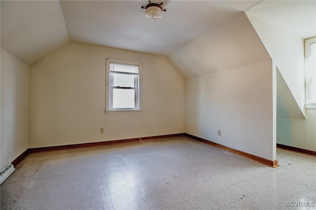 bonus room with baseboards, vaulted ceiling, and tile patterned floors