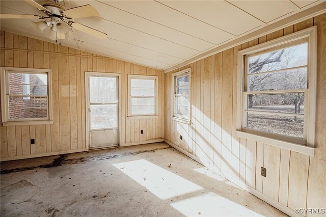 unfurnished sunroom with lofted ceiling, a wealth of natural light, and a ceiling fan