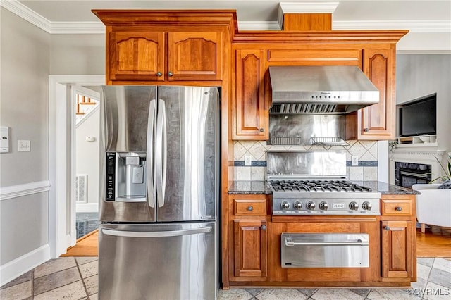 kitchen with a warming drawer, ornamental molding, stainless steel appliances, wall chimney range hood, and backsplash