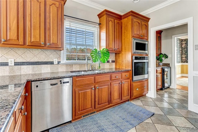 kitchen with beverage cooler, ornamental molding, appliances with stainless steel finishes, brown cabinetry, and a sink