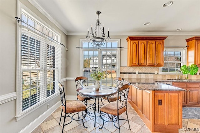 dining area featuring baseboards, recessed lighting, stone tile flooring, ornamental molding, and a notable chandelier