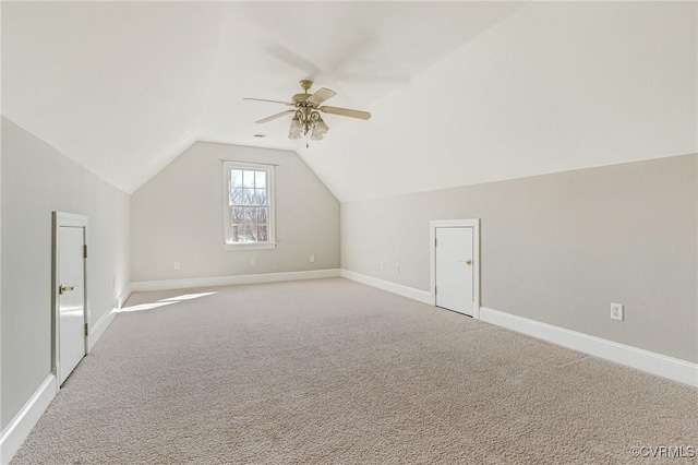 bonus room featuring lofted ceiling, carpet, baseboards, and ceiling fan