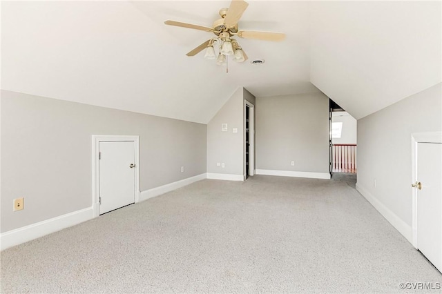 additional living space featuring visible vents, baseboards, carpet floors, vaulted ceiling, and a ceiling fan