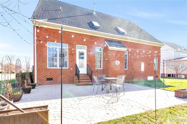 back of house with entry steps, brick siding, roof with shingles, and crawl space