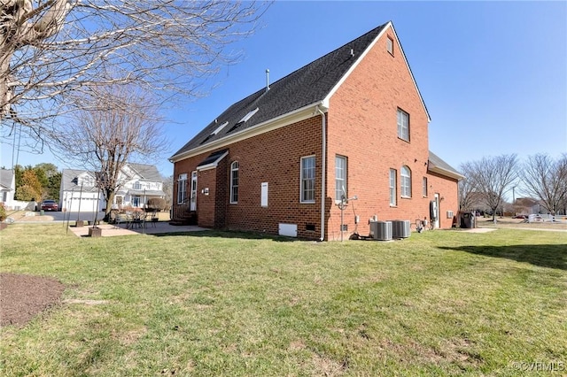 view of home's exterior featuring cooling unit, brick siding, a lawn, and a patio area