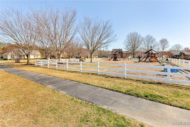 view of yard with playground community and fence