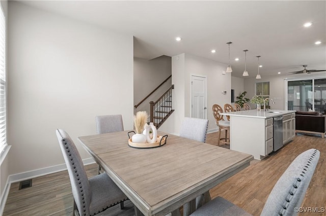 dining area featuring baseboards, stairway, light wood-style flooring, and recessed lighting