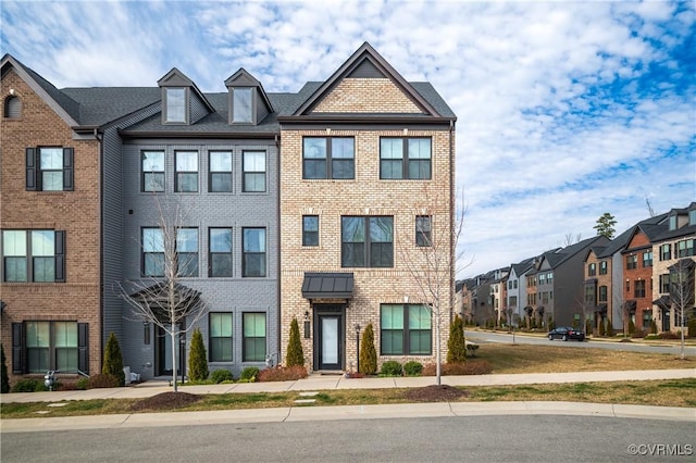 multi unit property featuring a residential view and brick siding