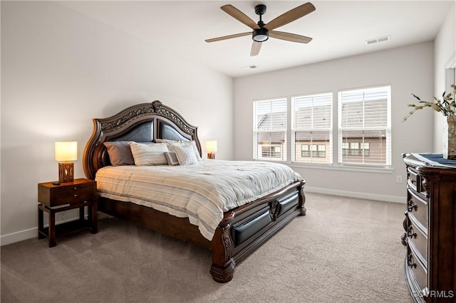 bedroom with a ceiling fan, light colored carpet, visible vents, and baseboards