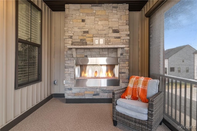 unfurnished room featuring carpet and a fireplace