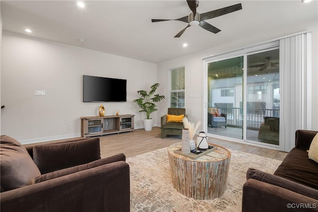 living room with recessed lighting, wood finished floors, and baseboards