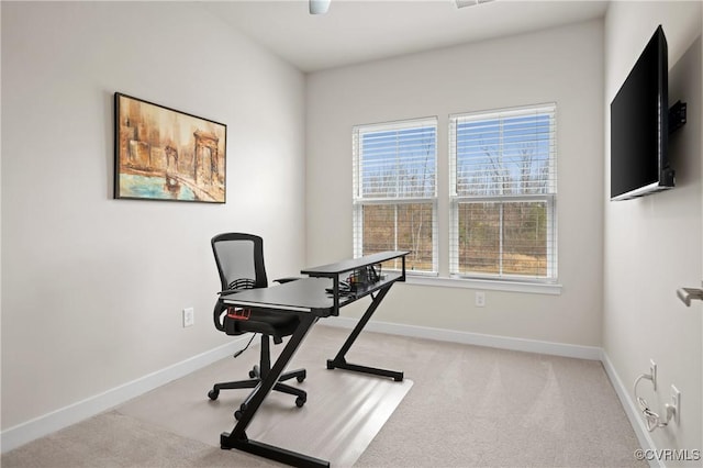 office space with light carpet and baseboards