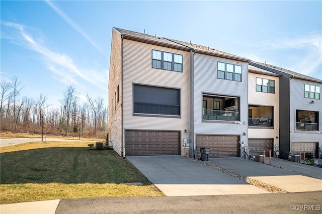 view of property with a garage, a front yard, and concrete driveway