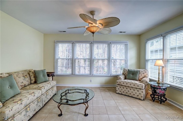 living room with baseboards, ceiling fan, visible vents, and tile patterned floors