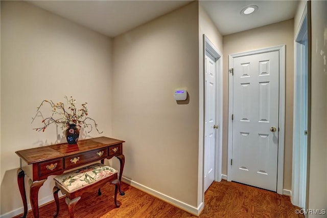 entryway featuring baseboards and wood finished floors