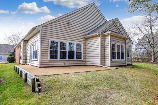 back of house with a patio area, a shingled roof, and a lawn