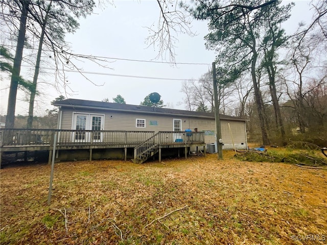 rear view of property with crawl space, stairs, a deck, and central AC