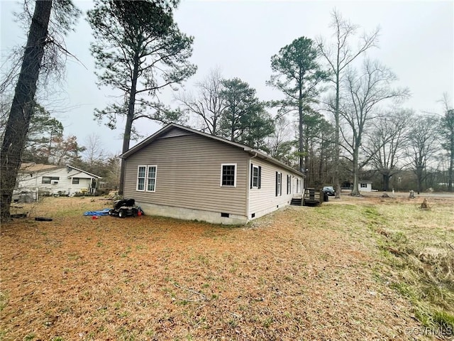 view of side of home with crawl space