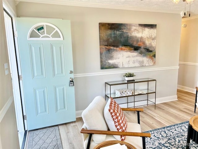 entryway featuring ornamental molding, baseboards, and wood finished floors