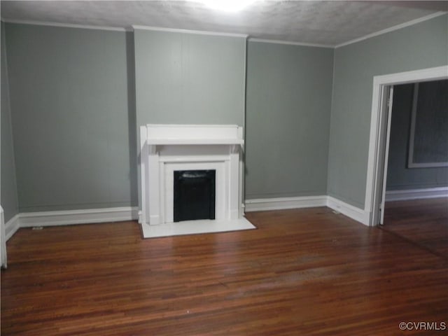 unfurnished living room with crown molding, a fireplace, baseboards, and wood finished floors