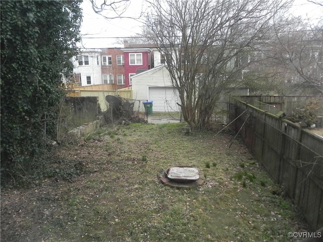 view of yard with a garage and fence