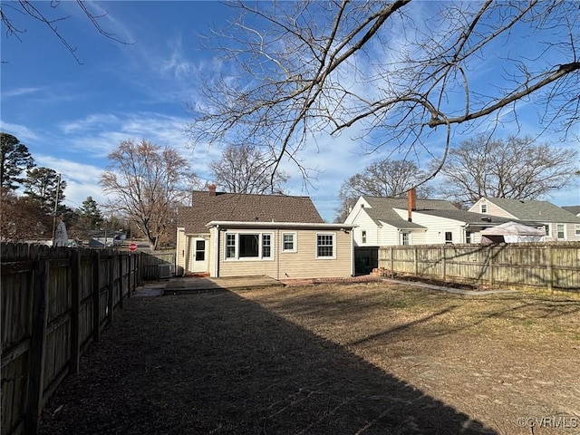 back of house featuring a fenced backyard