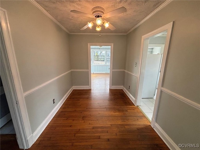 interior space featuring ceiling fan, a textured ceiling, ornamental molding, and hardwood / wood-style floors