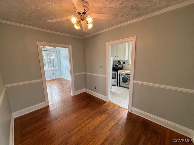 unfurnished room featuring ornamental molding, baseboards, and hardwood / wood-style flooring