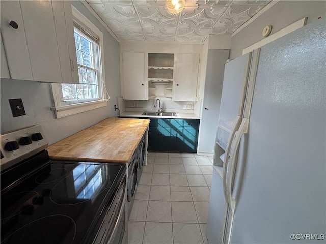 kitchen featuring an ornate ceiling, white refrigerator with ice dispenser, stainless steel electric range oven, open shelves, and a sink