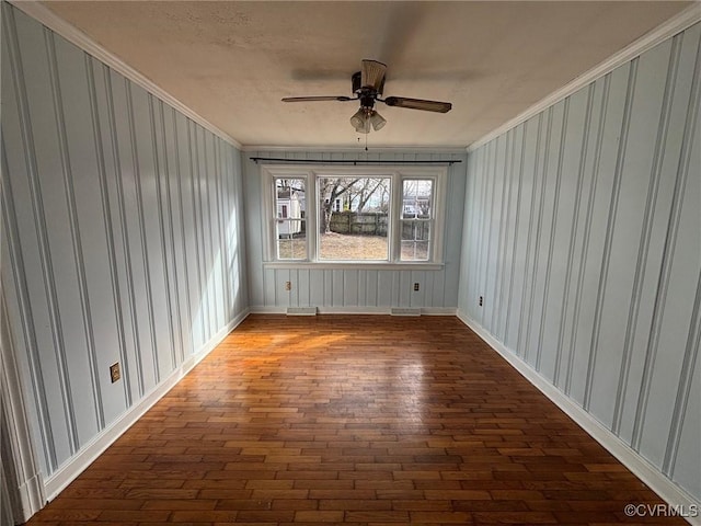 spare room with a ceiling fan, visible vents, and crown molding