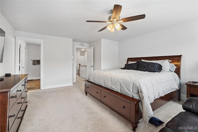 bedroom featuring light carpet, a ceiling fan, visible vents, and baseboards