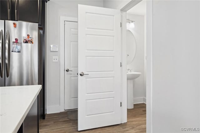 bathroom with wood finished floors and baseboards