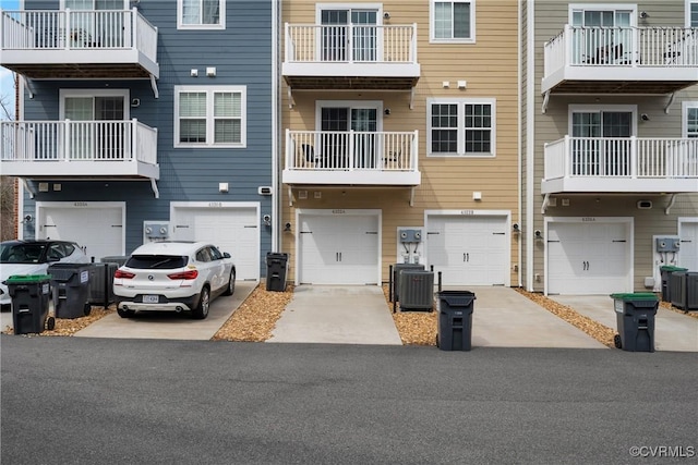 multi unit property featuring an attached garage and central AC