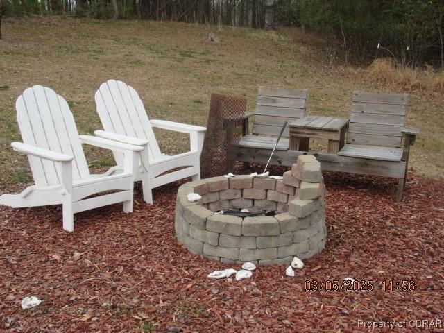 view of yard with a fire pit