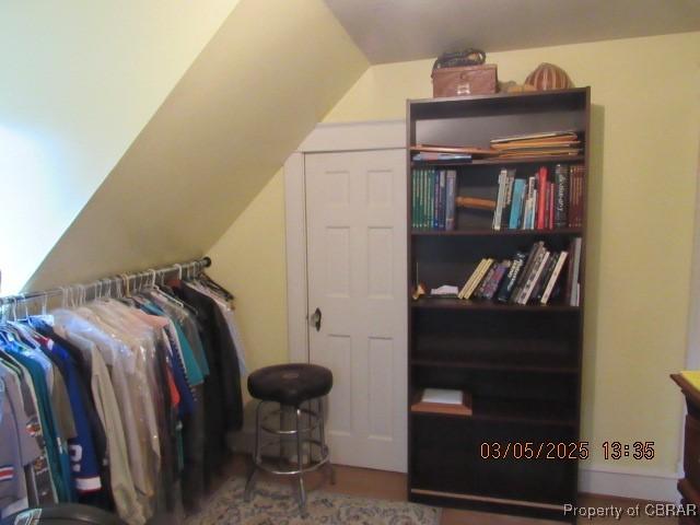 walk in closet with lofted ceiling